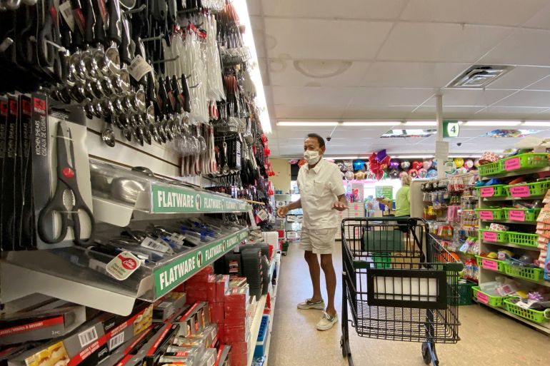 A US shopper wears a mask in a store in California