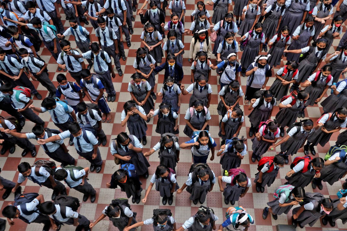 Schoolchildren assemble for morning prayers after schools in the western state of Maharashtra