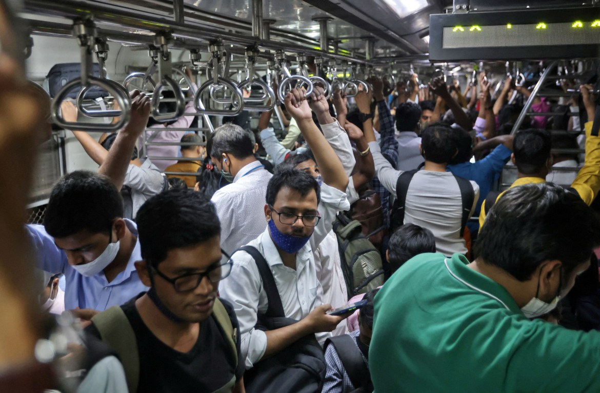 Commuters travel in a packed train in Mumbai, India