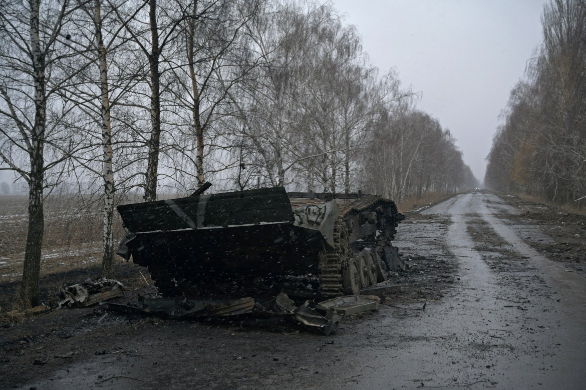 A destroyed armoured vehicle, with the letter "V" painted on it, is seen on a road, as Russia's invasion of Ukraine continues, near the village of Motyzhyn in the Kyiv region