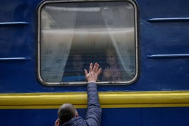 Children are seen looking out from an evacuation train from Kyiv to Lviv
