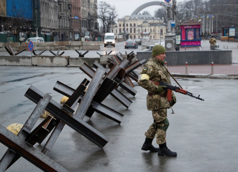 A member of the territorial defence force guards a checkpoint in Kyiv