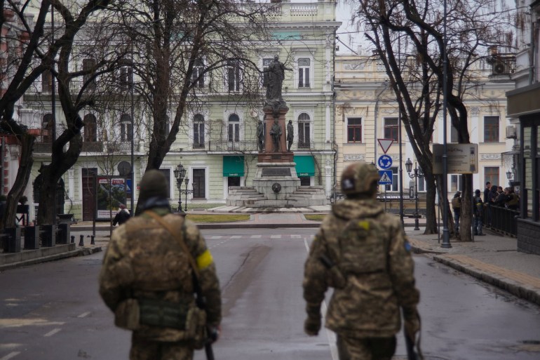 Members of Ukraine's Territorial Defence Forces patrol a street in Odesa