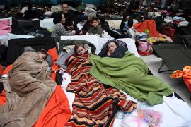 People lie on camp beds at a refugee reception centre at the Ukrainian-Polish border crossing in Korczowa