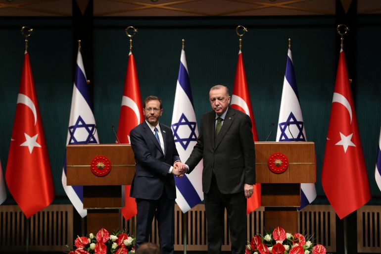 Turkish President Tayyip Erdogan and his Israeli counterpart Isaac Herzog shake hands during a joint news conference in Ankara, Turkey