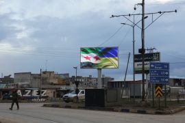 An electronic billboard depicting flags of Syrian opposition and Ukraine, in support of Ukraine amid Russia's invasion, is seen in the rebel-held city of Azaz, Syria.