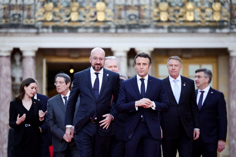 French President Emmanuel Macron, European Council President Charles Michel and EU leaders arrive for a family photo during an informal summit at the Chateau de Versailles (Versailles Palace),