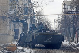 Pro-Russian troops drive an armoured vehicle with the letters "Z" painted on it in a residential area of the separatist-controlled town of Volnovakha during Ukraine-Russia conflict in the Donetsk region, Ukraine, March 11, 2022..