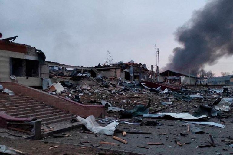Smoke rises amid damaged buildings following an attack on the Yavoriv military base.