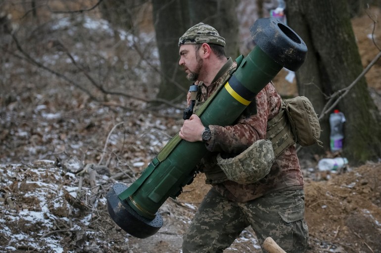 A Ukrainian service member holds a Javelin missile system