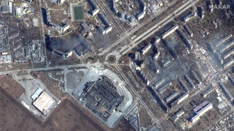 A satellite image shows burning and destroyed apartment buildings and the Port City Shopping Mall in western Mariupol, Ukraine, March 14, 2022.