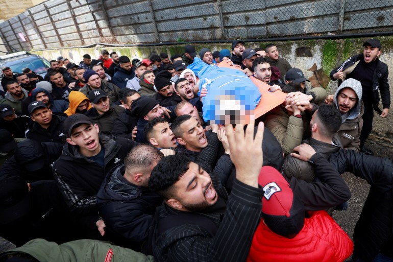 People carry the body of Palestinian Alaa Shaham, who was killed by Israeli forces
