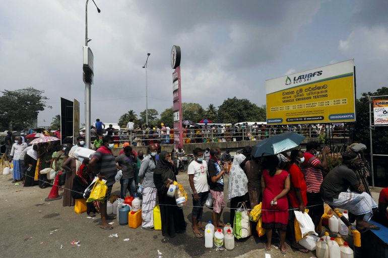 People stand in a long queue to buy kerosene oil due to shortage of domestic gas in Sri Lanka