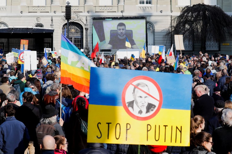 Ukraine's President Volodymyr Zelenskiy speaks during a demonstration for peace, via videolink, amid Russia's invasion of Ukraine, in front of the seat of the Swiss federal parliament Bundeshaus in Bern, Switzerland March 19, 2022. 