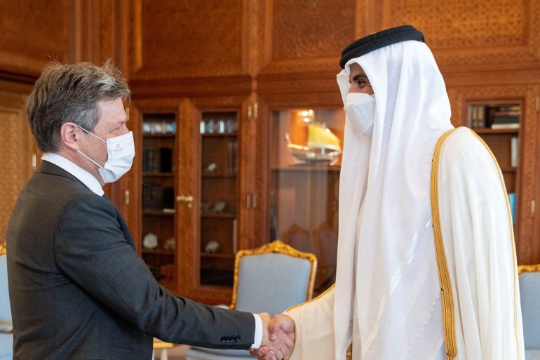 Qatari Emir Sheikh Tamim bin Hamad Al Thani shakes hands with German Economy Minister Robert Habeck, in Doha, Qatar