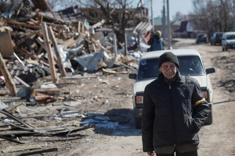 Resident walks in a destroyed village in Ukraine