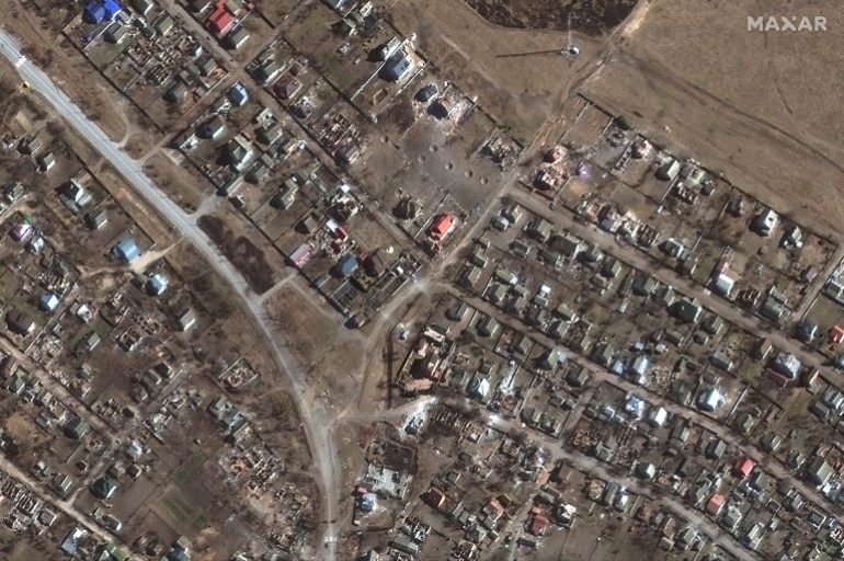 A satellite image shows large craters and destoyed homes in Novoselivka, Ukraine, March 21, 2022