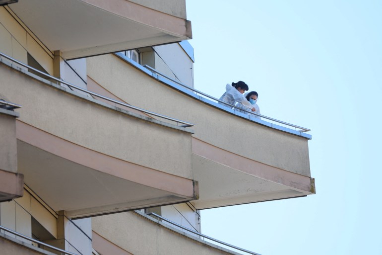 Police officers take samples on a balcony