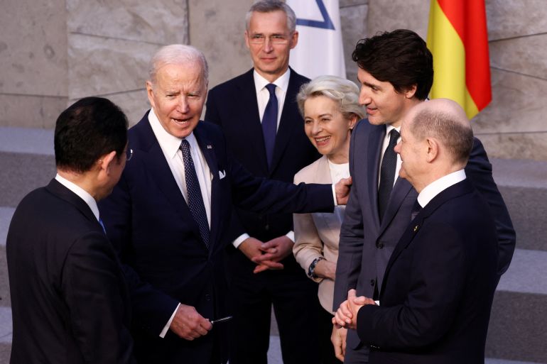 U.S. President Joe Biden speaks with Japan's Prime Minister Fumio Kishida, Germany's Chancellor Olaf Scholz, Canada's Prime Minister Justin Trudeau, European Commission President Ursula von der Leyen and NATO Secretary-General Jens Stoltenberg before a G7 leaders' family photo during a NATO summit on Russia's invasion of Ukraine, at the alliance's headquarters in Brussels, Belgium