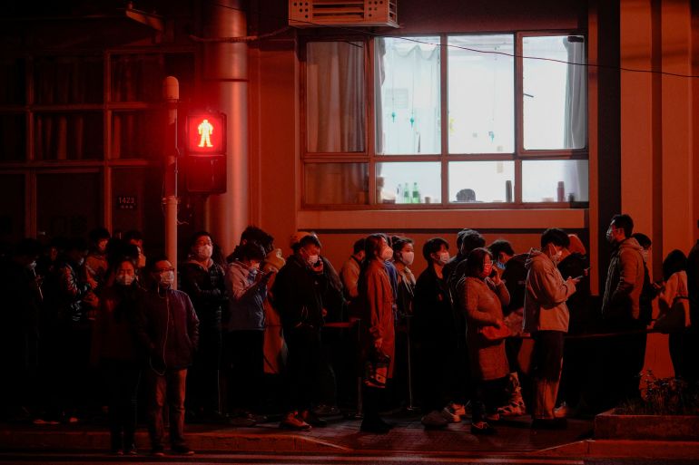 People line up near a nucleic acid testing site outside a hospital in Shanghai, China during mass COVID testing