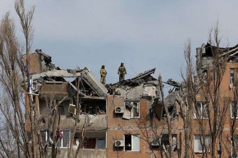Firefighters work at a residential building damaged by shelling during Ukraine-Russia conflict in the separatist-controlled city of Donetsk, Ukraine March 30, 2022.