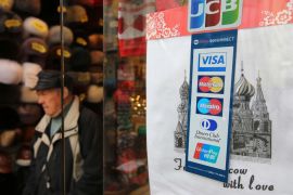 Logos for Visa Inc., Mastercard Inc., Diners Club International Ltd. and China UnionPay Data Co. payment services sit in the window of a souvenir store in Moscow, Russia