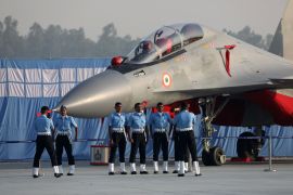 Members of the Indian Air Force (IAF) pose for a photograph in front of a Sukhoi 30 MKII fighter jet in India
