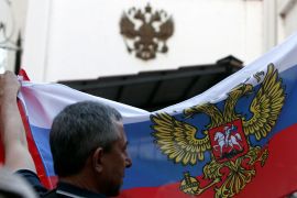 A man waves Russian flag during a rally in front of the Russian Embassy in Skopje, North Macedonia