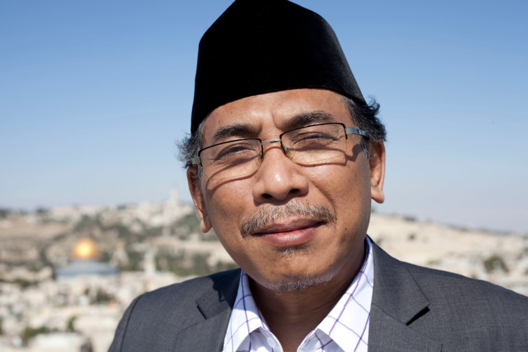 A portrait of Yahya Staquf, wearing a traditional oval black songkok on his head
