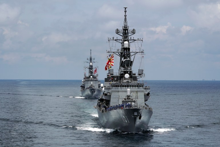 A photo of Japan's Maritime Self-Defense Force (JMSDF) destroyers JS Murasame (DD-101), front, and JS Akebono (DD-108) participate in a drill off the coast of Brunei.