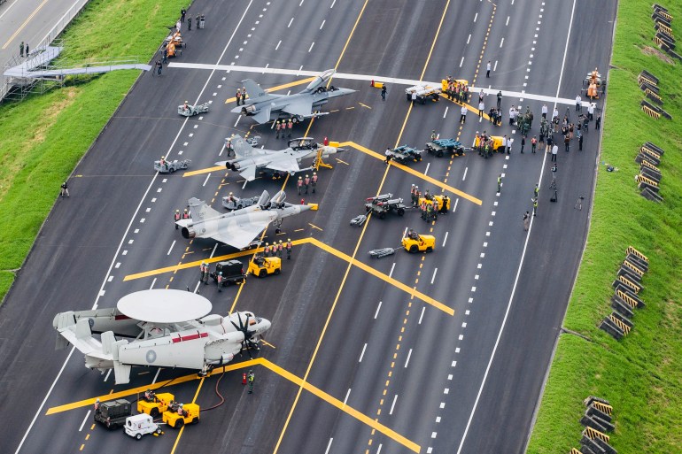 A photo of Taiwan war planes are parked on a highway.