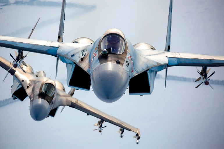 FILE - In this photo released by the Russian Defense Ministry Press Service, a pair of Russian Su-35 fighter jets fly in the sky in Russia, Nov. 28, 2021. The amassing of Russian troops and equipment near Ukraine's border has caused worries in Kyiv and in the West that Moscow could be planning to launch an invasion. Russia, the United States and its NATO allies are meeting this week for negotiations focused on Moscow's demand for Western security guarantees and Western concerns about a recent buildup of Russian troops near Ukraine.