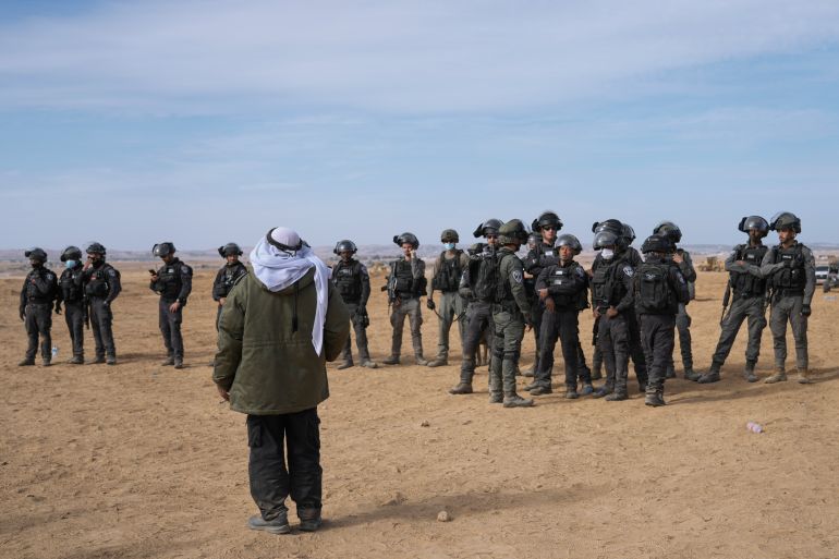 Israeli security forces stand guard as Bedouins protest tree-planting by the Jewish National Fund on disputed land near a Bedouin village