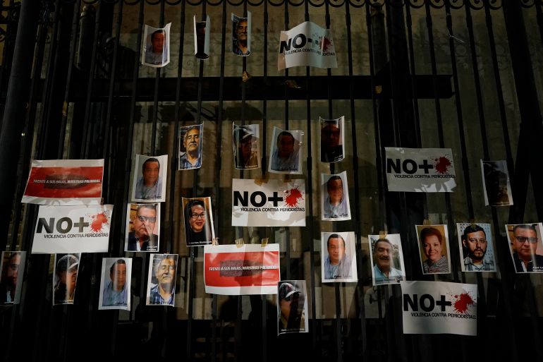 Photos of slain journalists are posted on the gate of Mexico's Attorney General's office