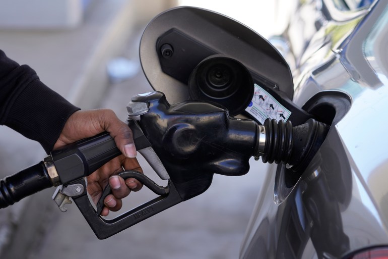 A motorist pumps gasoline at a Mobil gas station