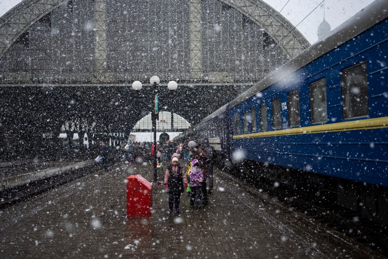 A Ukrainian family are seen at the Lviv railway station