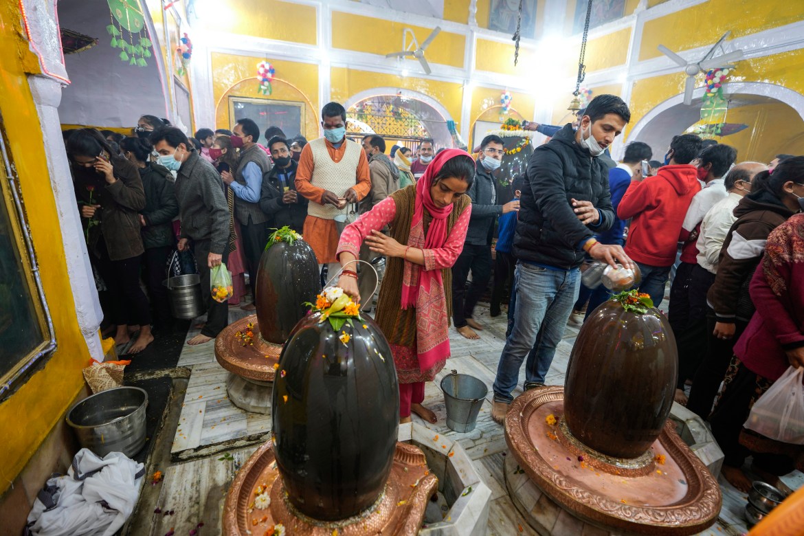 Hindu devotees worship Shivling, a representation of Hindu god Shiva, during Shivratri festival in Jammu, India.