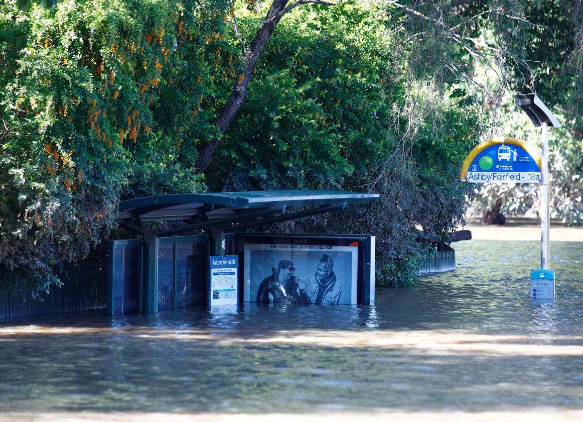 A bus shelter is submerged under water in Brisbane, Australia,