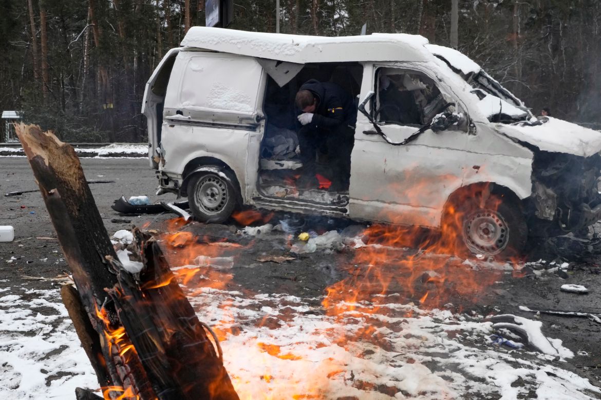 A man reacts inside a vehicle damaged by shelling, in Brovary, outside Kyiv