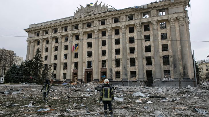 A member of the Ukrainian Emergency Service looks at the City Hall building in the central square following shelling in Kharkiv, Ukraine, Tuesday, March 1, 2022. (AP Photo/Pavel Dorogoy)