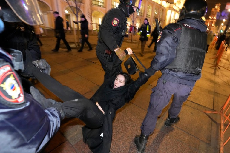 Police arrest a demonstrator during an action against Russia's attack on Ukraine in St. Petersburg