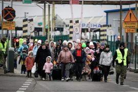 People fleeing Ukraine enter Poland through the border crossing Korczowa, Poland