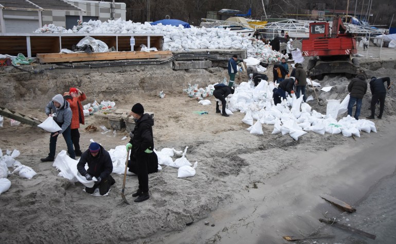 Volunteers fill sandbags to build barricades in Odesa