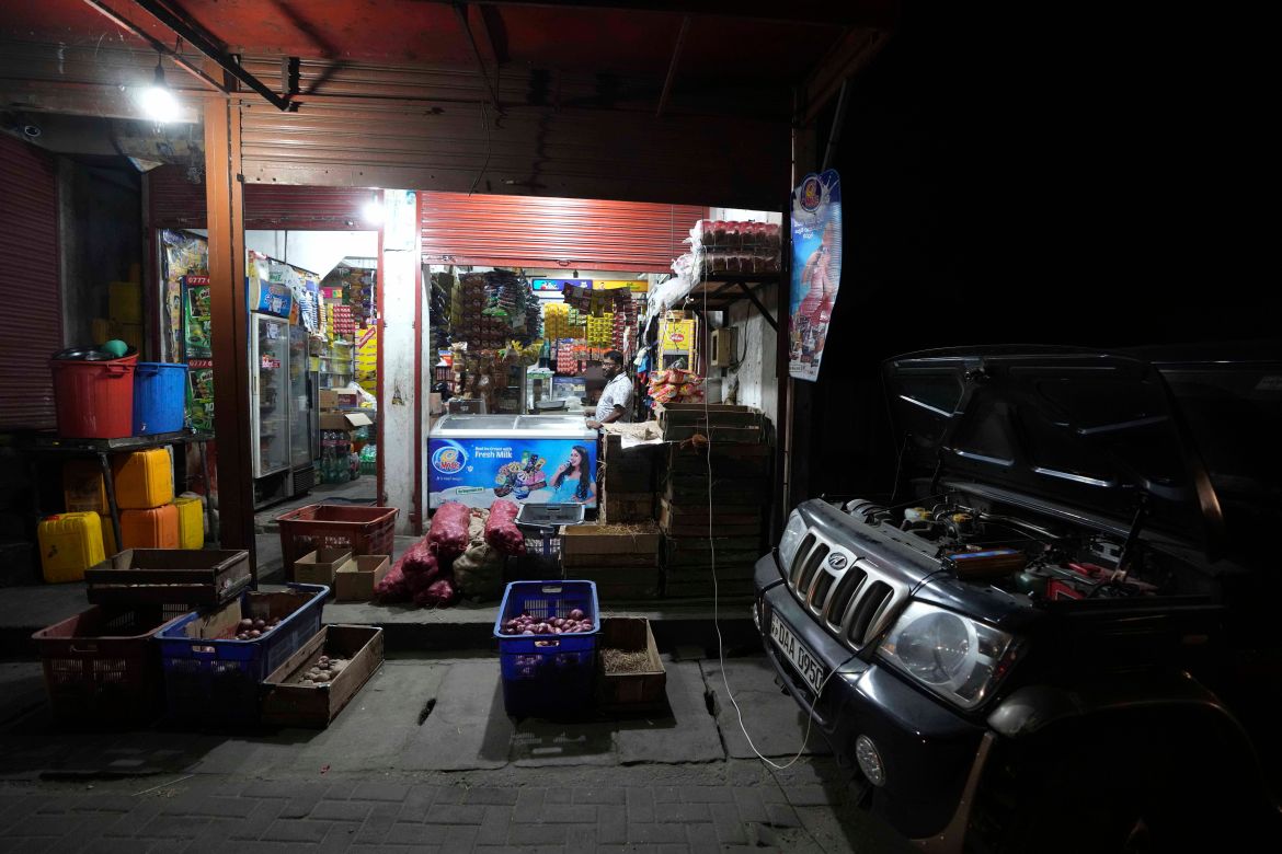 A Sri Lankan retailer uses his diesel powered truck to light up his sales outlet in Kelaniya