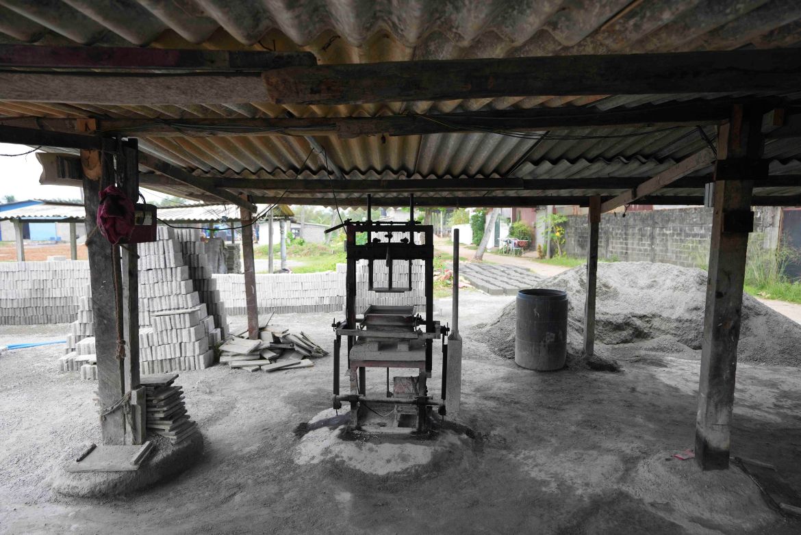 A cement brick making machine is seen idle without operation during a power cut in Hendala