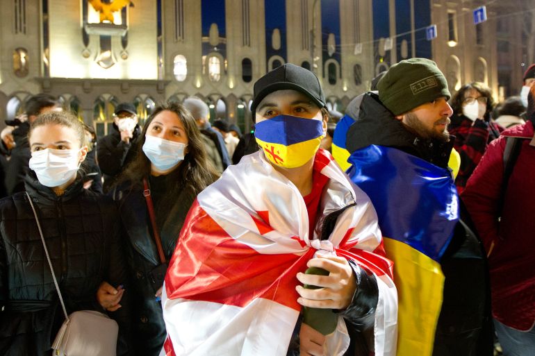 A demonstrator with the Ukraine and Georgia flags in Tbilisi