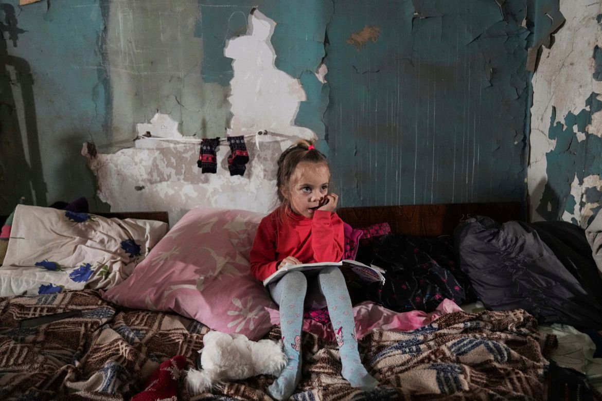 A girl sits in the improvised bomb shelte