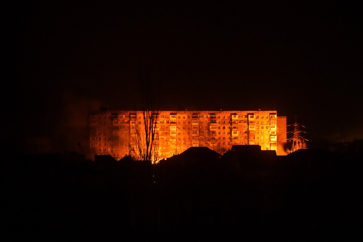 A fire is seen in a settlement area after shelling in Mariupol