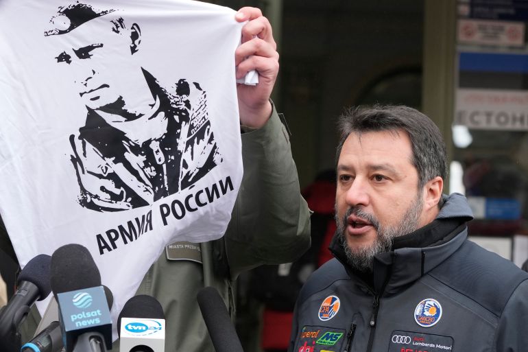 The Mayor of Przemysl, Wojciech Bakun, left, holds up a t-shirt with the likeness of Russian President Vladimir Putin and the words "The Russian Army" as Italy's League Party leader