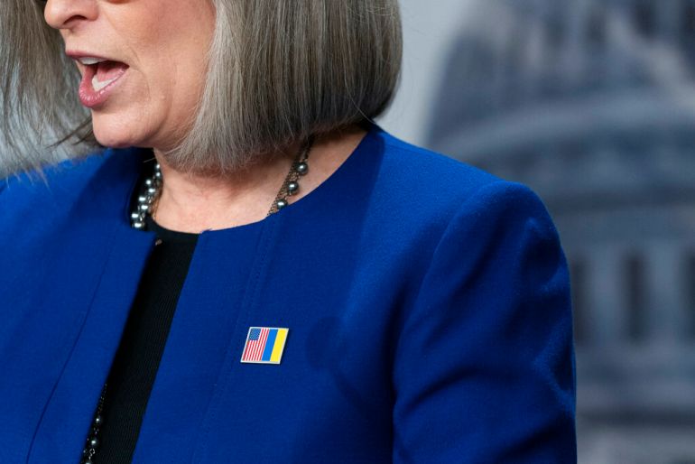 Republican Senator Joni Ernst wears a pin that combines the red, white and blue flag of the United States with the blue and yellow of Ukraine to show off the beleaguered Eastern European nation.